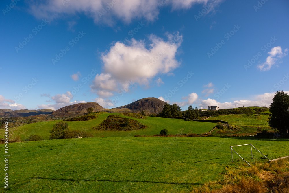 Fototapeta premium Green Hills and Countryside View with Distant Mountains, Snowdonia, Wales