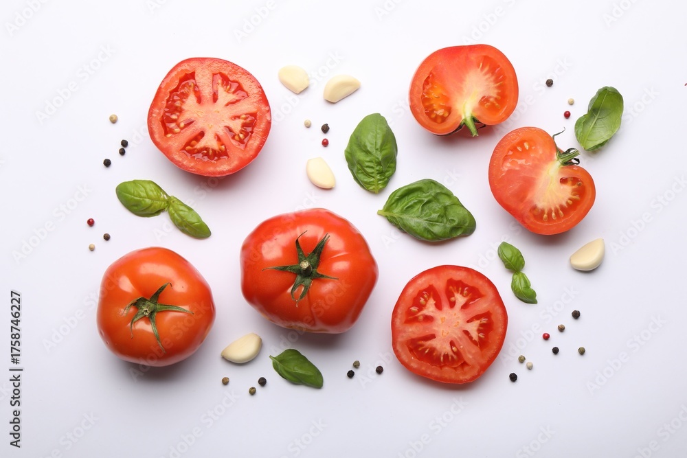 Fototapeta premium Ripe red tomatoes, peppercorns, garlic and basil on white background, flat lay