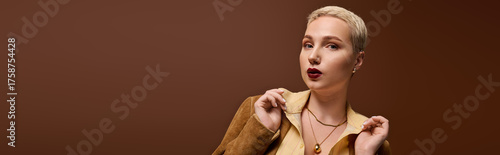 Fashionable young woman exudes confidence in warm toned studio setting