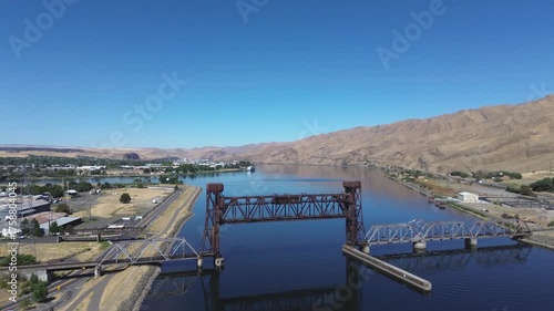 Railroad lift bridge over the Snake River in Lewiston Idaho. Flyover shot of the bridge in a high desert setting with a calm Snake River below.