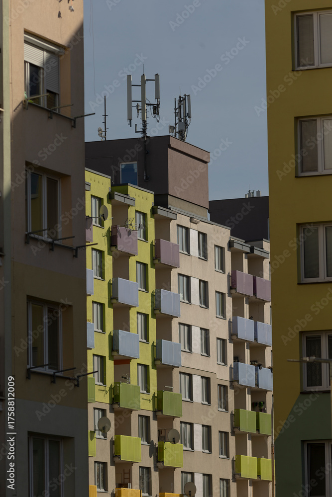 Fototapeta premium photographer captures vibrant urban landscape, street photographer captures lively city with shadows and colors, vivid street scene featuring colorful buildings and striking shadows at city outskirts