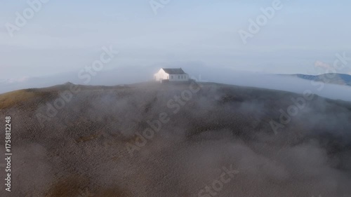 Amazing 4K aerial video of flying above and around Most Famous mountain in Ireland - Croagh Patrick in windy weather, with moving fog and clouds with breathtaking views around, Westport, Ireland
