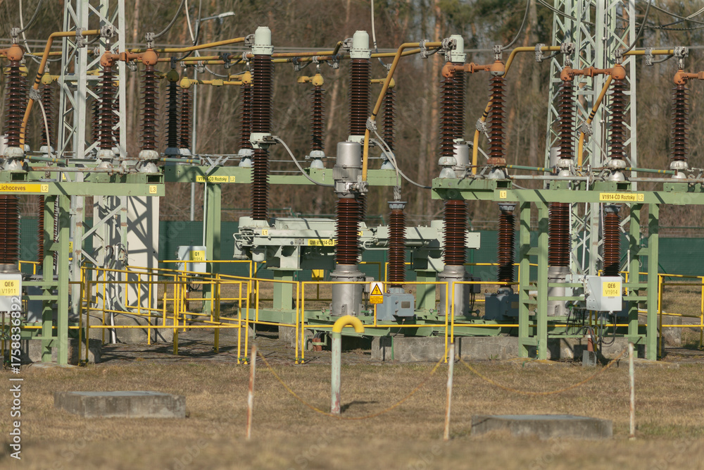 Fototapeta premium crossarm power pole with birds perched on insulators and wires against clear blue sky, juxtaposition of nature and electricity, calm outdoor scene highlighting perching behavior and utility structure