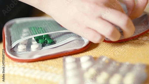 Woman prepares a travel first aid kit for any situation.