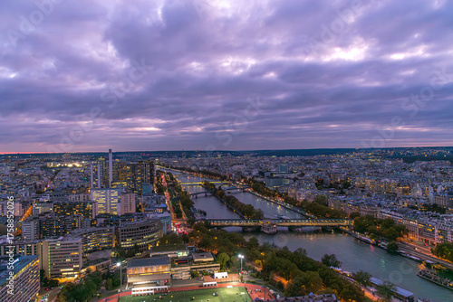 Fototapeta Naklejka Na Ścianę i Meble -  Paris illuminated at nightfall, seen from the top of the Eiffel Tower, with illuminated buildings and streets