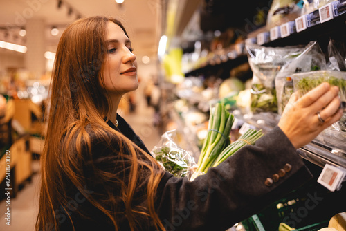 Business woman buy healthy food item. Girl take vegan herb. Adult lady shop eco market. Bio farm grocery store. Buyer girl put organic meal cart. Person keep raw diet. Client go local supermarket. 