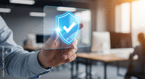 Man holding virtual shield with check mark. Cybersecurity and data protection concept. Digital safety and privacy for online business.