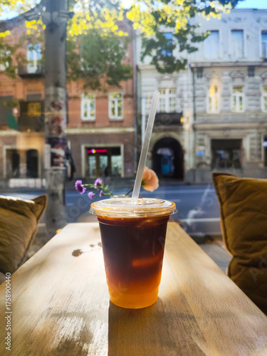 Bumble coffee drink on a wooden table, iced bumble in cafe. Bumble, or Orange Espresso is a refreshing mocktail drink that combines espresso or coffee with orange juice