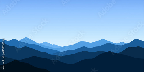 Mountain landscape view of majestic peaks under a beautiful sky with soft clouds and morning fog