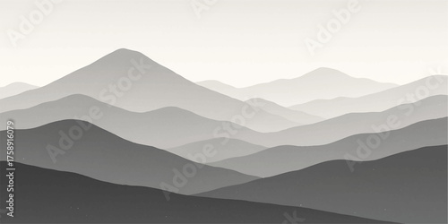 Mountain landscape with misty blue peaks at sunrise, showcasing a vast nature view with clouds and fog in the valley