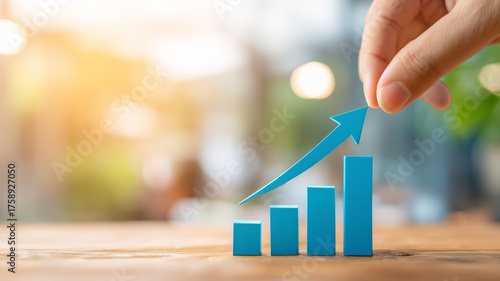 Hand guiding a rising bar chart to illustrate business growth strategic planning and measurable performance improvement.
