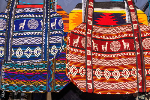 Textile bags with traditional Andean patterns at the weekly Plaza de los Ponchos market in Otavalo, Ecuador