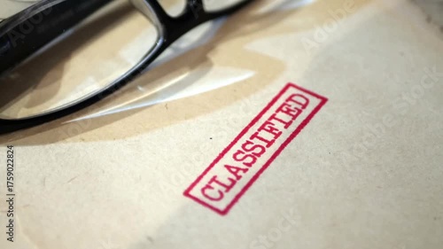 An old  sensitive documents and secret information with the stamp CLASSIFIED dolly shot