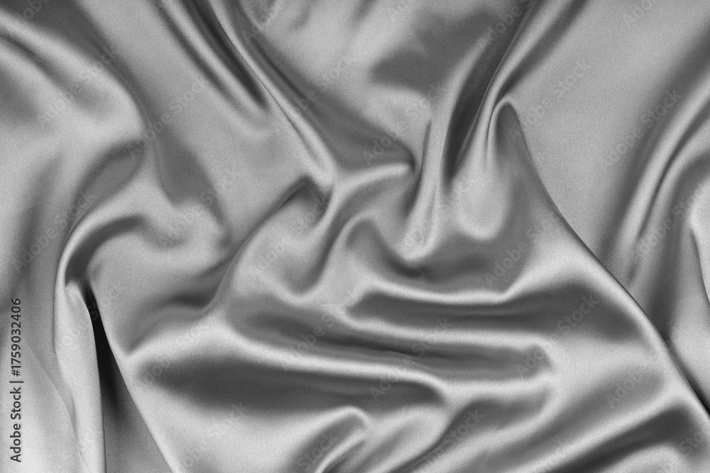 Fototapeta premium Crumpled, wrinkled gray colored glossy silk satin texture. Shiny smooth fabric with soft folds, cloth with wave drapery. Elegant and rich background, wallpaper, backdrop. Flat lay, top view