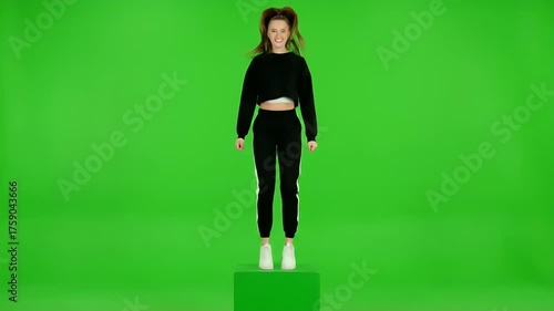 Young Woman Jumping and Dancing on a Green Screen Stage.