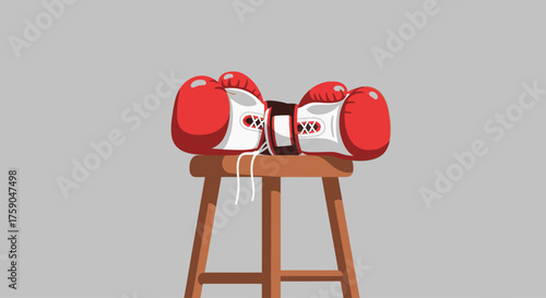 A pair of red boxing gloves resting on a wooden corner stool, symbolizing the quiet moment of preparation before a fight or training session