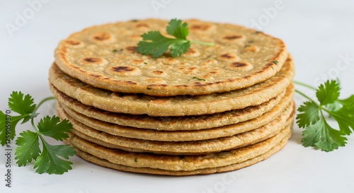 Stack of golden brown flatbreads with fresh cilantro garnish roti chapati