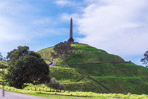 Majestic monument on verdant hill, historic landmark against blue sky