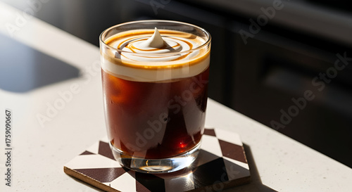 Close-up of an iced coffee with cream served on a coaster in bright light no comma at the end