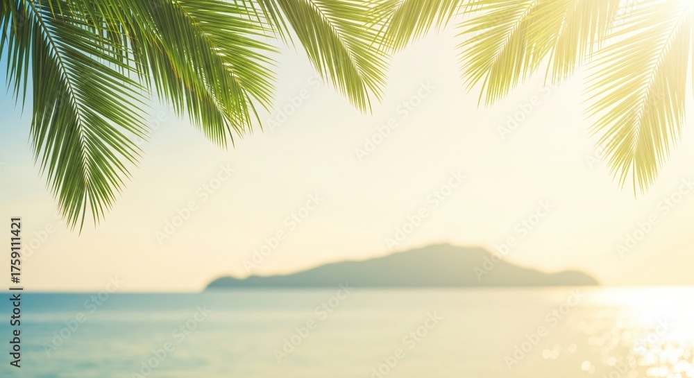 Fototapeta premium Lush green palm fronds hang over a calm turquoise sea and distant island bathed in soft sunlight