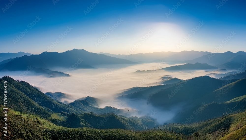 Obraz premium Misty Morning Mountains with Sunlight Streaming Through Fog 
