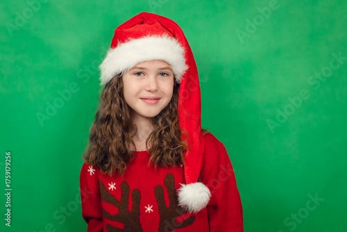 New Year Portrait Of Cute Teenage Girl In Santa Hat On Green Background, Looking At Camera, Smiling, Chroma Key