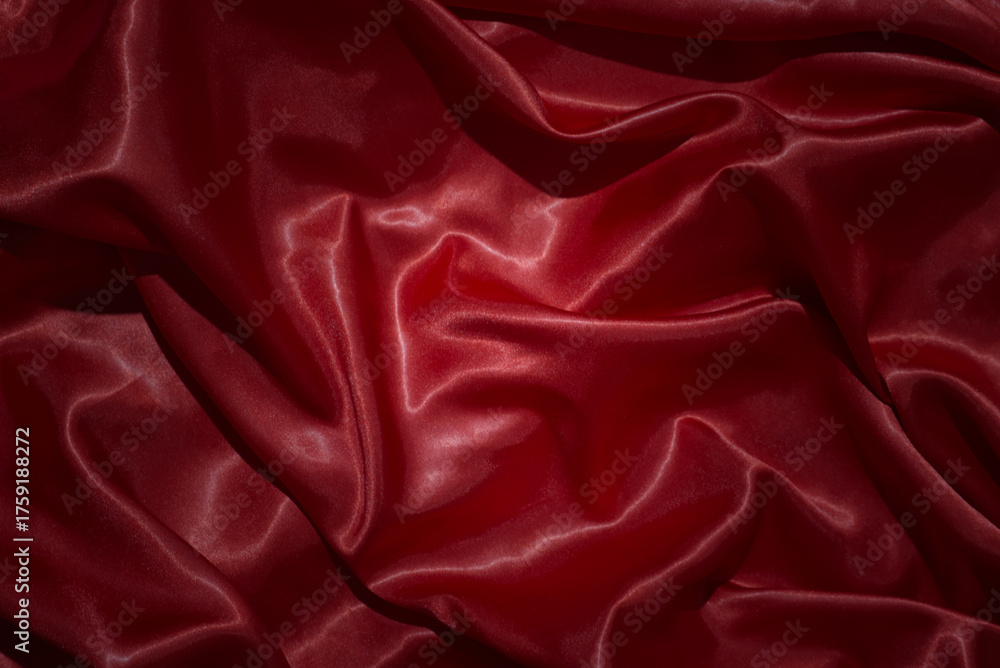 Obraz premium top view close-up of red satin fabric, smooth and luxurious, beautiful, classy, ​​wavy texture