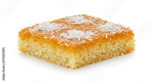Isolated basbousa garnished with coconut shavings on a plain white background for dessert or bakery photography