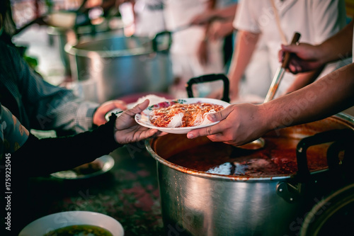The hand of a beggar received food from a compassionate person, Concept of sharing