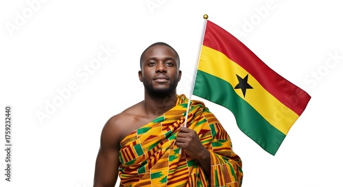 A proud Ghanaian man dressed in traditional Kente cloth holding the national flag of Ghana with a look of determination