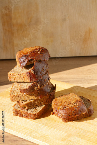 sliced bread piled up in a pyramid on a wooden surface