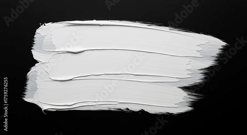 A bold abstract brush stroke of thick white acrylic paint applied with a palette knife onto a stark black background creating a textured artistic expression