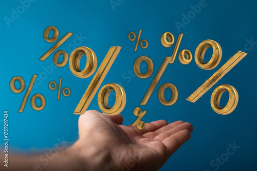 Hand holding golden percent...