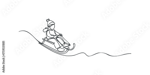Child sledding downhill in winter