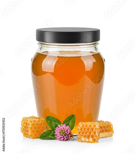 Oval Shaped Glass Jar of Orange Blossom Honey with matte cap without label area and surrounded by fresh orange blossom flower, honeycomb and leaves