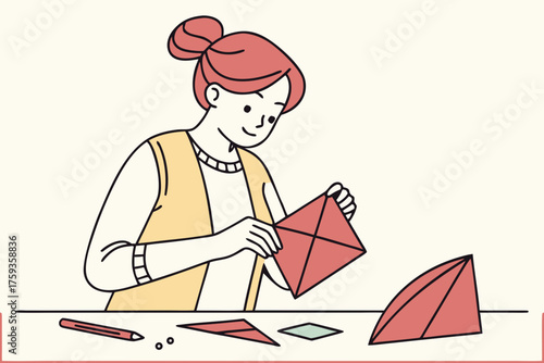 Woman creating origami paper shape at a table