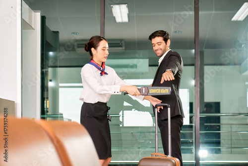 Air groud woman staff use scan stick for checking security by airline policy to businessman with black suit at the airport.