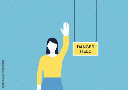 Woman Raises Hand Near Danger Field Sign.