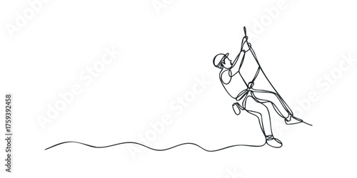 Rock climber rappelling down a cliff face