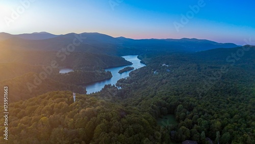 Panoramic aerial view of the Plitvice Lakes in Croatia, surrounded by an autumn forest in the sunset. 