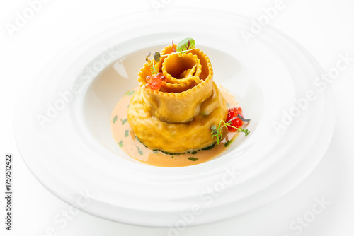 Fotografie Gourmet filled pasta plated with creamy orange sauce, microgreens, and red garnish