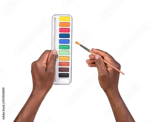 Man holding a paint palette and an art brush in hands and painting isolated on white or transparent background