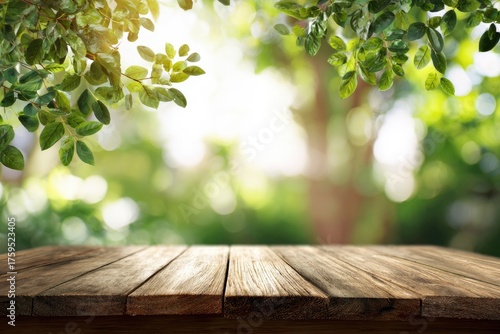 Rustic wooden tabletop against blurred background of lush green foliage and bright sunlight