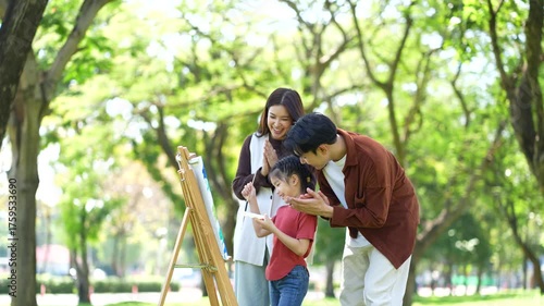 Happy asian family picnic in park, weekend lifestyle outdoors.
