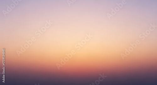 A soft, hazy gradient of pastel colors transitions from deep purple at the bottom to a warm orange and then a pale pink at the top, evoking a serene sunset or sunrise.