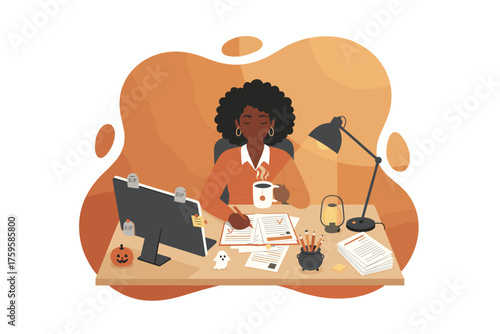 Focused African American woman working at her Halloweendecorated desk enjoying a warm drink