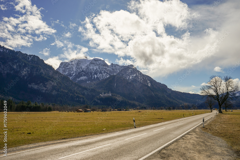 Fototapeta premium A road with a Alps mountain in the background
