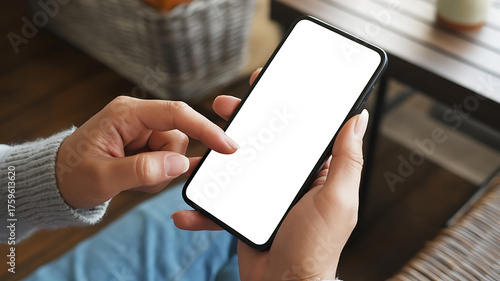 Close-up of a hand holding a device, displaying a blank screen, modern technology in use.