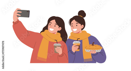 Two happy young women in autumn clothes taking a selfie while holding coffee and a pumpkin pie.