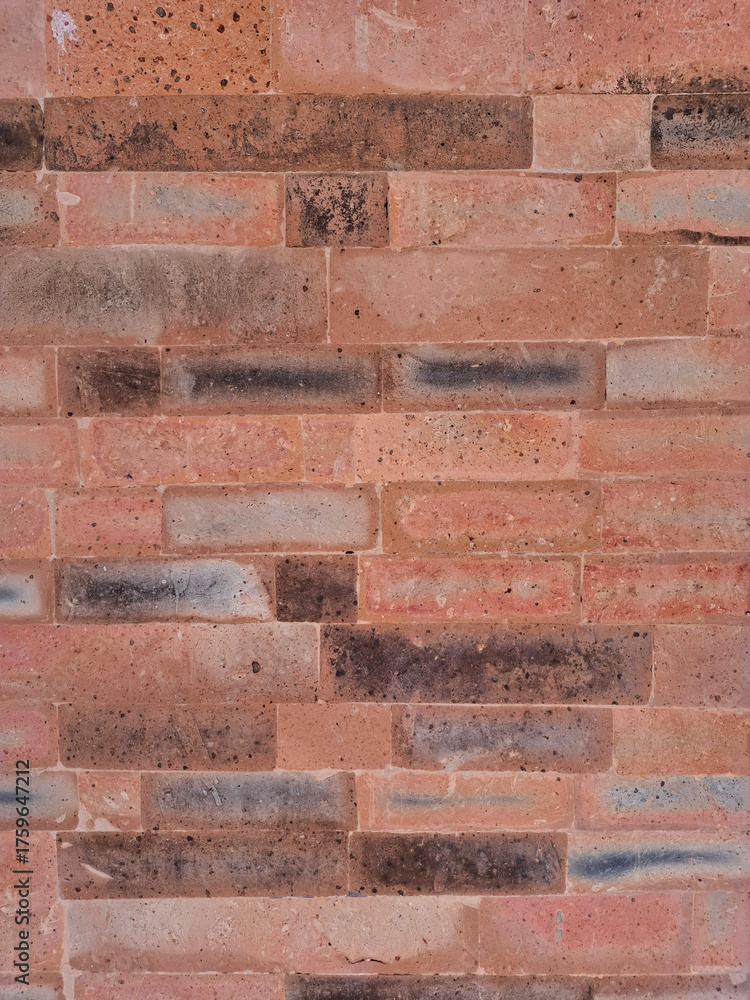 Obraz premium Close up of orange aged brick masonry texture suitable as a neutral background or backdrop for design projects.